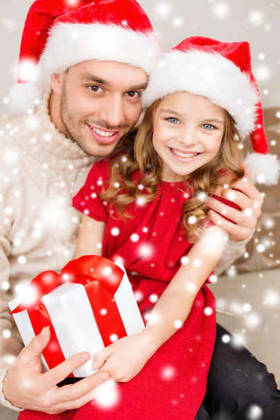 Smiling father and daughter holding gift box - Photo, image