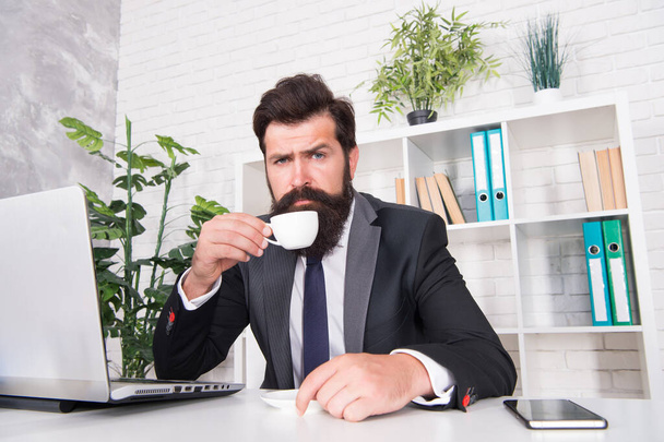 Comfy workspace. Bearded hipster formal suit relaxing with coffee. Office life is unthinkable without good coffee. Reception room. Respectable ceo. Man handsome boss sit in office drinking coffee - Fotografie, Obrázek