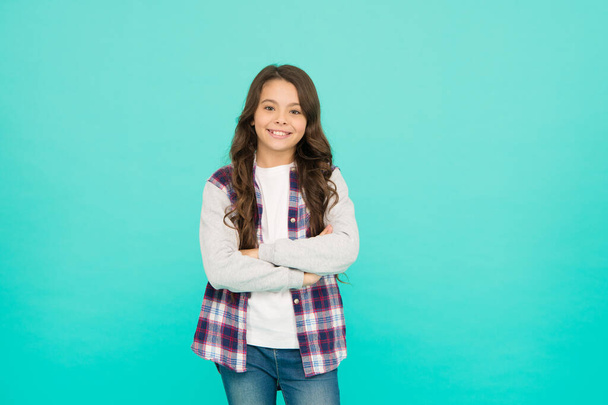 Living happy life. Good mood concept. Positive vibes. Sincere emotions. Cute girl with long hair. Small girl checkered shirt. Happy international childrens day. Little girl turquoise background - Foto, afbeelding
