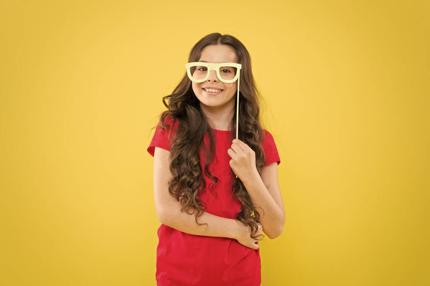 Start this party. Every child deserve happy childhood. Small child with happy smile and funny look through glasses props. Happy little girl smile yellow background. Happy international childrens day - Zdjęcie, obraz