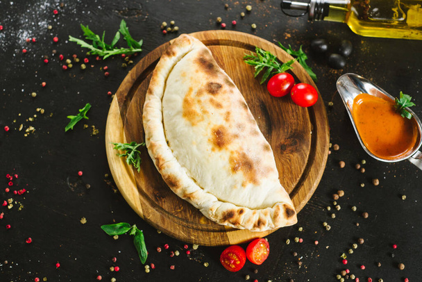 Tasty lavash pie with meat and vegetables on black - Foto, Imagem