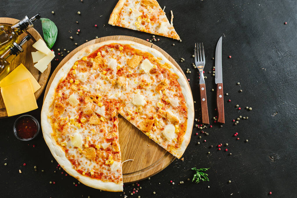 Tasty pizza with ham, corn and cheese on black background - Foto, Imagen