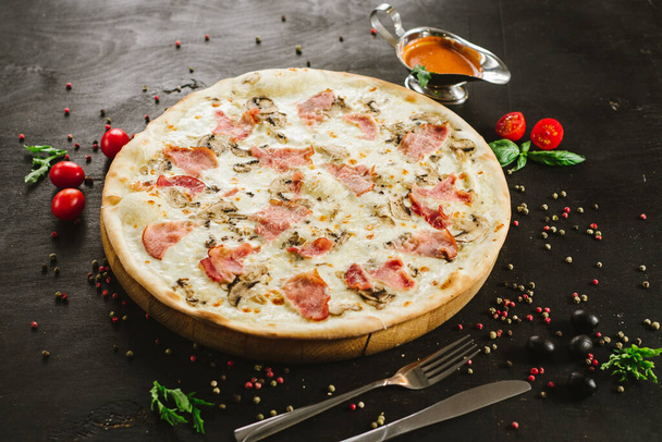 Tasty meat pizza with various ingredients on black background - Фото, зображення