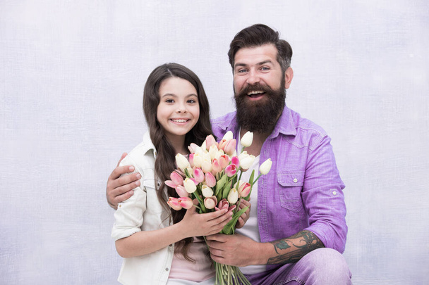 Birthday celebration. Man tulips bouquet. Father giving tulips girl. Dad with flowers. International womens day. Flower shop. Family tradition. She worth all treasures. Tender tulips for daughter - Zdjęcie, obraz