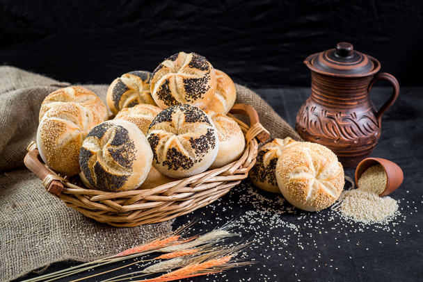 Sweet tasty buns in the basket on black wooden baclground - Foto, Bild
