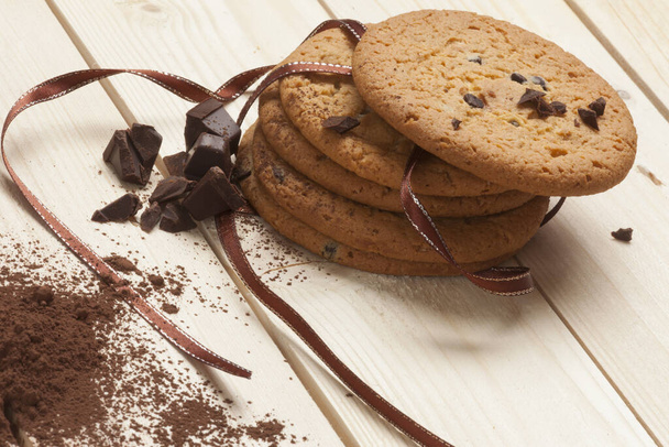 cinnamon and chocolate chip cookies chocolate chips on a wooden background - Photo, Image