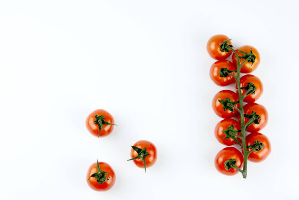 small cherry tomatoes on a white background - Fotó, kép