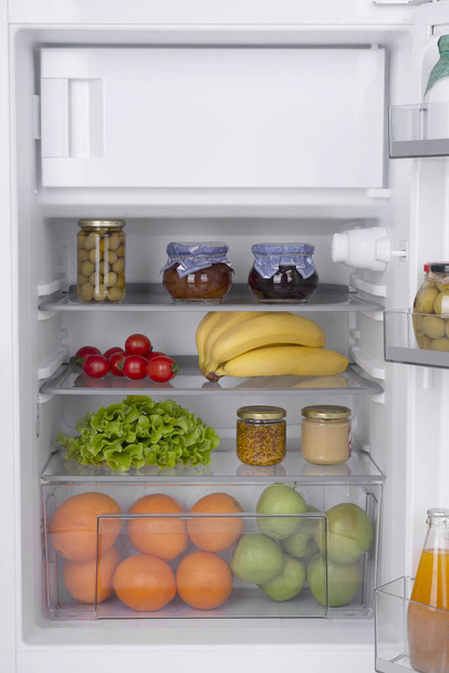 Open fridge full of fresh fruits and vegetables, healthy food background, organic nutrition, health care, dieting concept - Photo, image