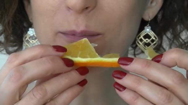 a woman has a sweet and juicy orange - Footage, Video