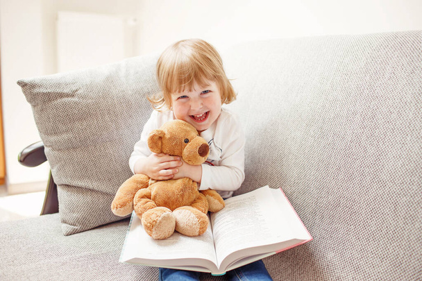 Smiling girl holding teddy bear - Photo, Image
