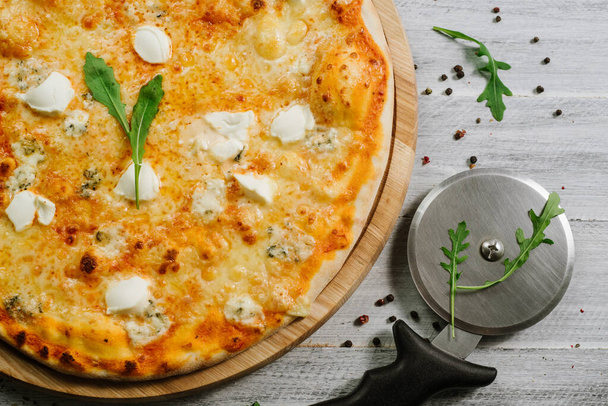 Pizza Formaggio with mozzarella, emental cheese, and cheese philadelphia on wooden background - Fotoğraf, Görsel