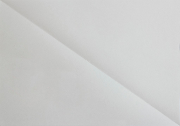 Blank diagonaly folded sheet of paper. background - Photo, Image