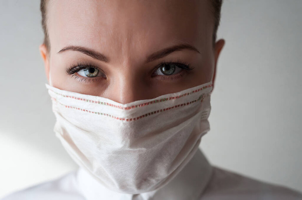 Portrait of a girl in a medical mask. Close u - Photo, Image