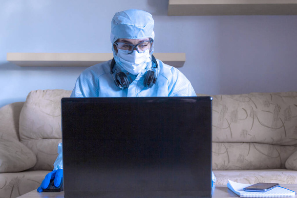 Work from home with laptop under social distancing and self isolation due to covid-19 virus. Online education and remote freelance work during quarantine. Coronovirus outbreak and stay home concept - Foto, Imagem