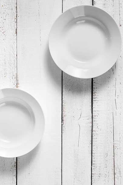 white plates on a white wooden background - Photo, Image