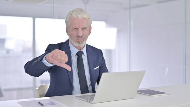 Old Businessman doing Thumbs Down in Office - Photo, Image
