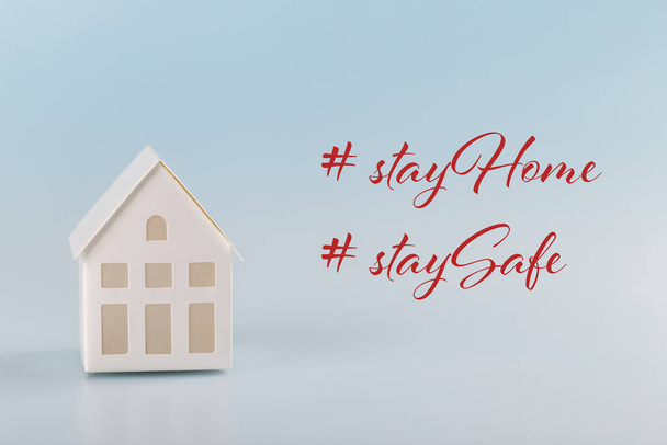 White toy house on blue background, Stay home Stay safe, social media campaign, stop coronavirus, self isolation, world's pandemic prevention - Photo, Image