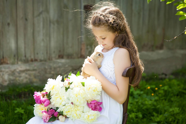Портрет милої дівчини з чарівною кролицею в літньому саду. Великодня концепція
 - Фото, зображення