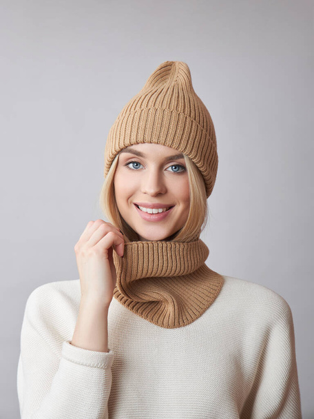 Blonde woman with long hair wearing a hat and a white sweater. Beauty portrait of a girl, natural cosmetics - 写真・画像
