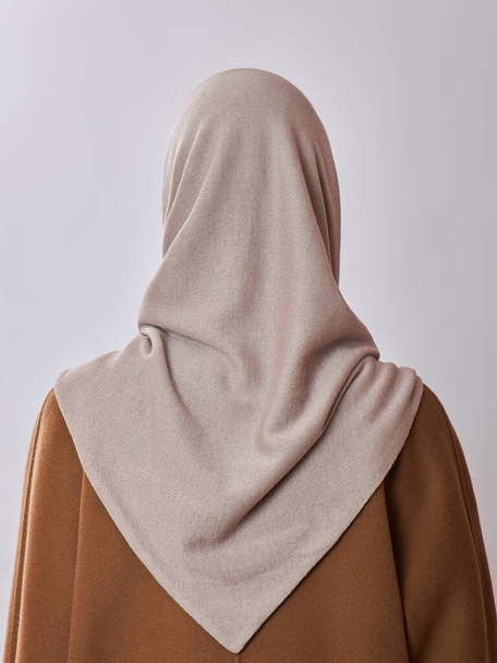 European Muslim woman with a blonde hair in a headscarf shawl dressed on her head. Beautiful girl in coat with soft skin, natural cosmetics - Фото, зображення