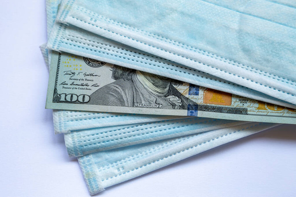 Billetes de los Estados Unidos de América y una máscara protectora contra el virus. Crisis económica mundial asociada al coronovirus. - Foto, imagen