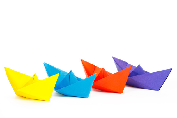 Four colored paper ship on a white background - 写真・画像