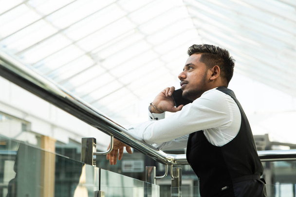 Portrait of a businessman in suit are standing on the background of glass offices. - Foto, imagen