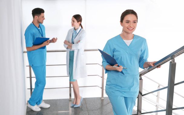 Female doctor going upstairs in modern clinic - Foto, Imagem