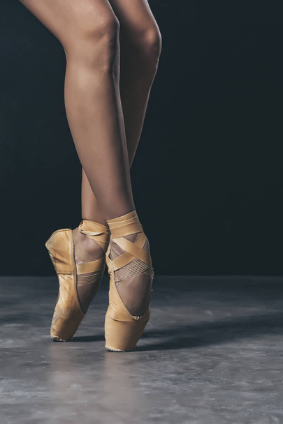 ballerina dancer shoes on the toes on balck background - 写真・画像