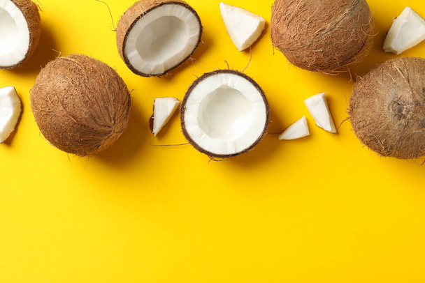 Flat lay with coconut on yellow background, space for text - Foto, imagen