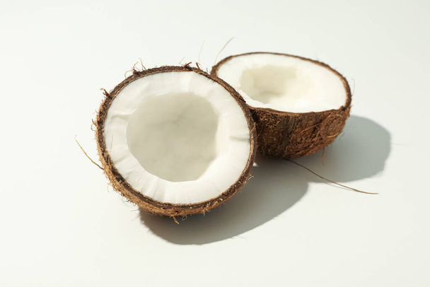 Halves of coconut on white background, close up - Фото, изображение