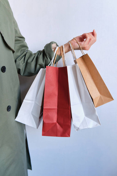 Happy woman holding in hand shopping package. Paper bag. Sale in store. Beautiful young girl in fashion shop. Customer buy present. Black friday sale. Holiday special offer, discount. Female in market - Φωτογραφία, εικόνα