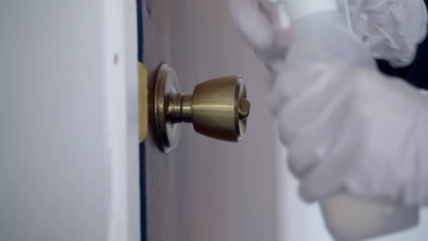 Disinfection. Precautions for the epidemic of the virus. Coronavirus quarantine. Hands in latex gloves wipe the door handle with a disinfector. Surface treatment with alcohol. Stay home. Outbreak. - Video