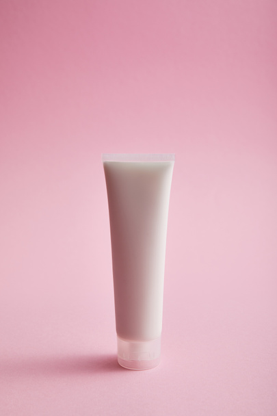 Cosmetic hand cream tube on pink background - Фото, зображення