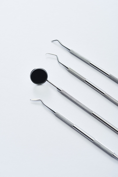 High angle view of professional dental tools for teeth examination on grey background - Foto, afbeelding