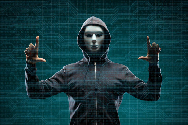 Dangerous hacker over abstract digital background with binary code. Obscured dark face in mask and hood. Data thief, internet attack, darknet fraud, virtual reality and cyber security concept. - 写真・画像