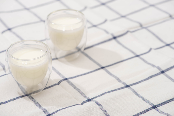 High angle view of glasses of homemade yogurt on plaid fabric - Valokuva, kuva