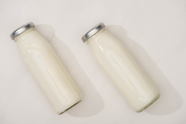 Top view of bottles of yogurt on white background - Photo, Image