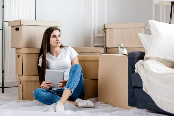 young woman making online purchases for her new apartment - Photo, Image
