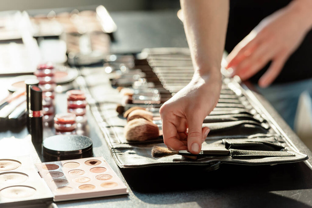 cropped view of makeup artist touching cosmetic brush - 写真・画像