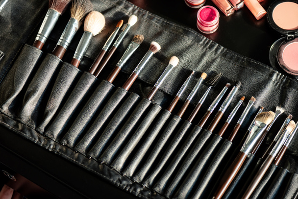 top view of makeup brush set near container with lipstick  - 写真・画像