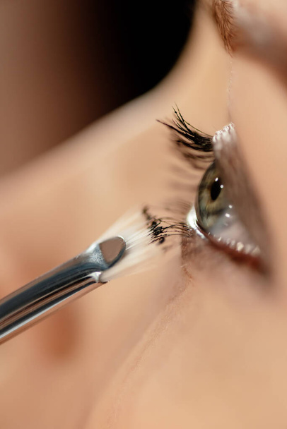 close up of cosmetic brush near eye of model - Photo, image
