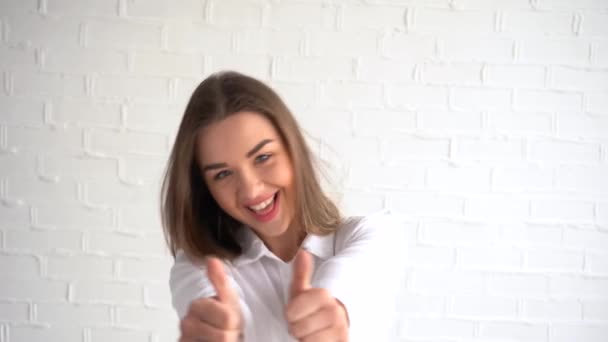 cheerful beautiful woman raises her thumb up on a bent fist. A smile on his face, fun and joy. everything will be fine4K - Footage, Video