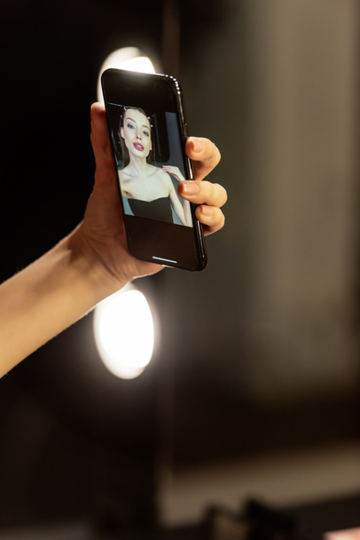 attractive woman taking selfie in photo studio  - Φωτογραφία, εικόνα