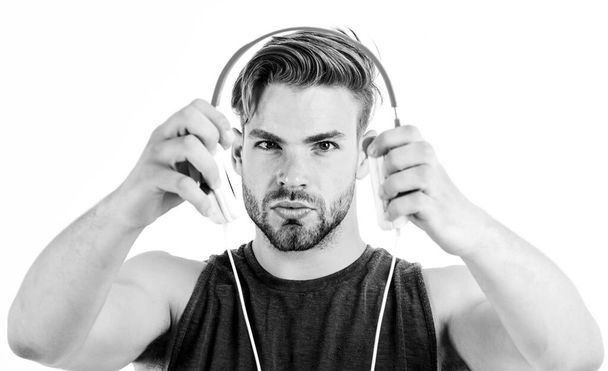 man giving headphones. mp3 player. sexy muscular man listen music on phone mp3 player. man with mp3 player on phone isolated on white. unshaven man in headphones - Fotoğraf, Görsel