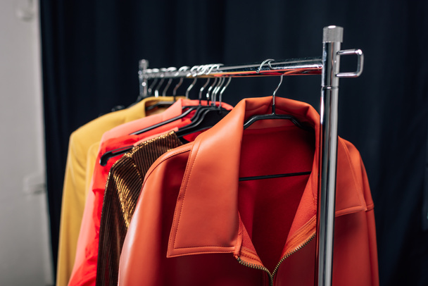 selectieve focus van hanger met stijlvolle jassen in fotostudio - Foto, afbeelding