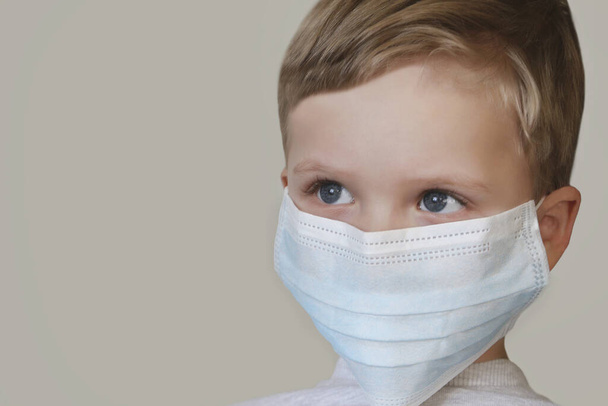 Дитина в синій медичній масці. Закрита фотографія. Захист здоров'я від різних вірусів і захворювань
. - Фото, зображення