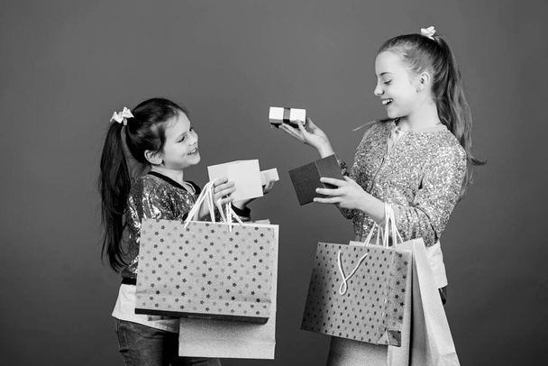 Girls sisters friends with shopping bags blue background. Every product delivered to you. Shopping and purchase. Black friday. Sale and discount. Children bunch packages. Shopping day. Kids fashion - Foto, Imagen