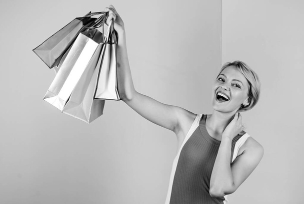 Pleasant shopping. big sale. female shopaholic hold shopping bags. present packages for holiday preparation. summer discount. special offer on black friday. shop closeout. happy woman shopper - Foto, imagen