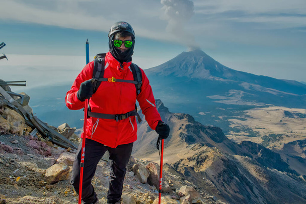 Hiker watches Volcano Popocatepetl erupt trekking in Iztaccihuatl Popocatepetl National Park, Mexico - Photo, Image